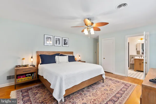 a bedroom with bed and wooden floor