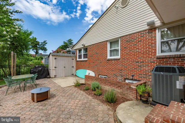 a wooden bench sitting in front of a house