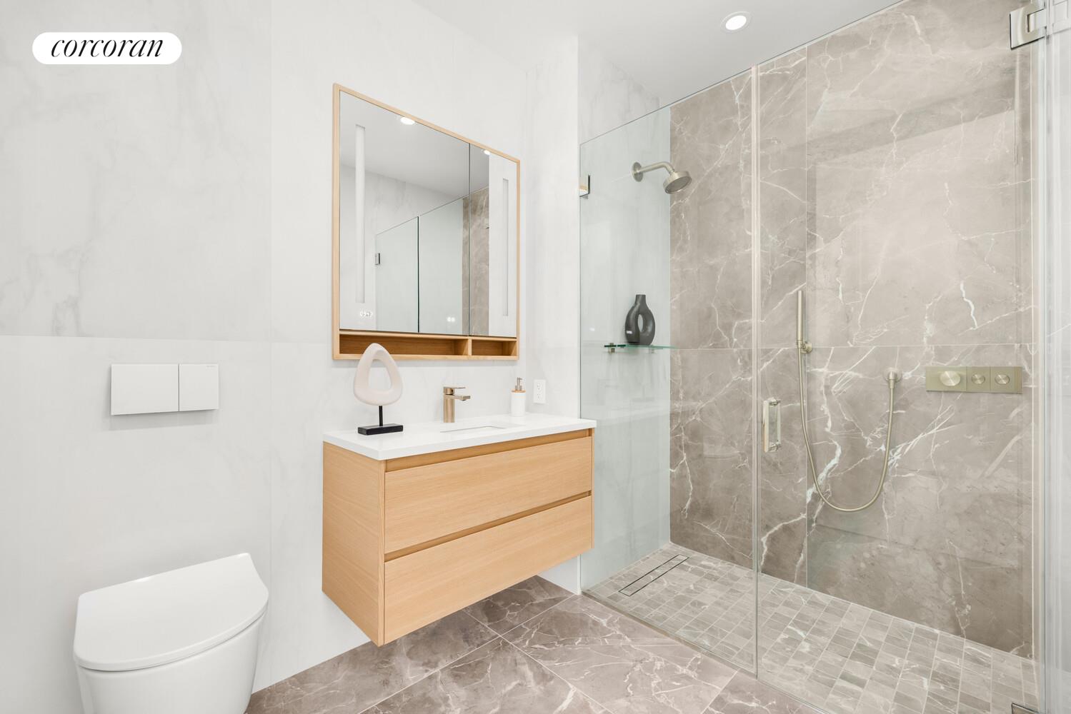 420 East 75th Street, Unit 2 Manhattan, NY 10021 - Photo 11 of 22 a bathroom with a sink a toilet and shower