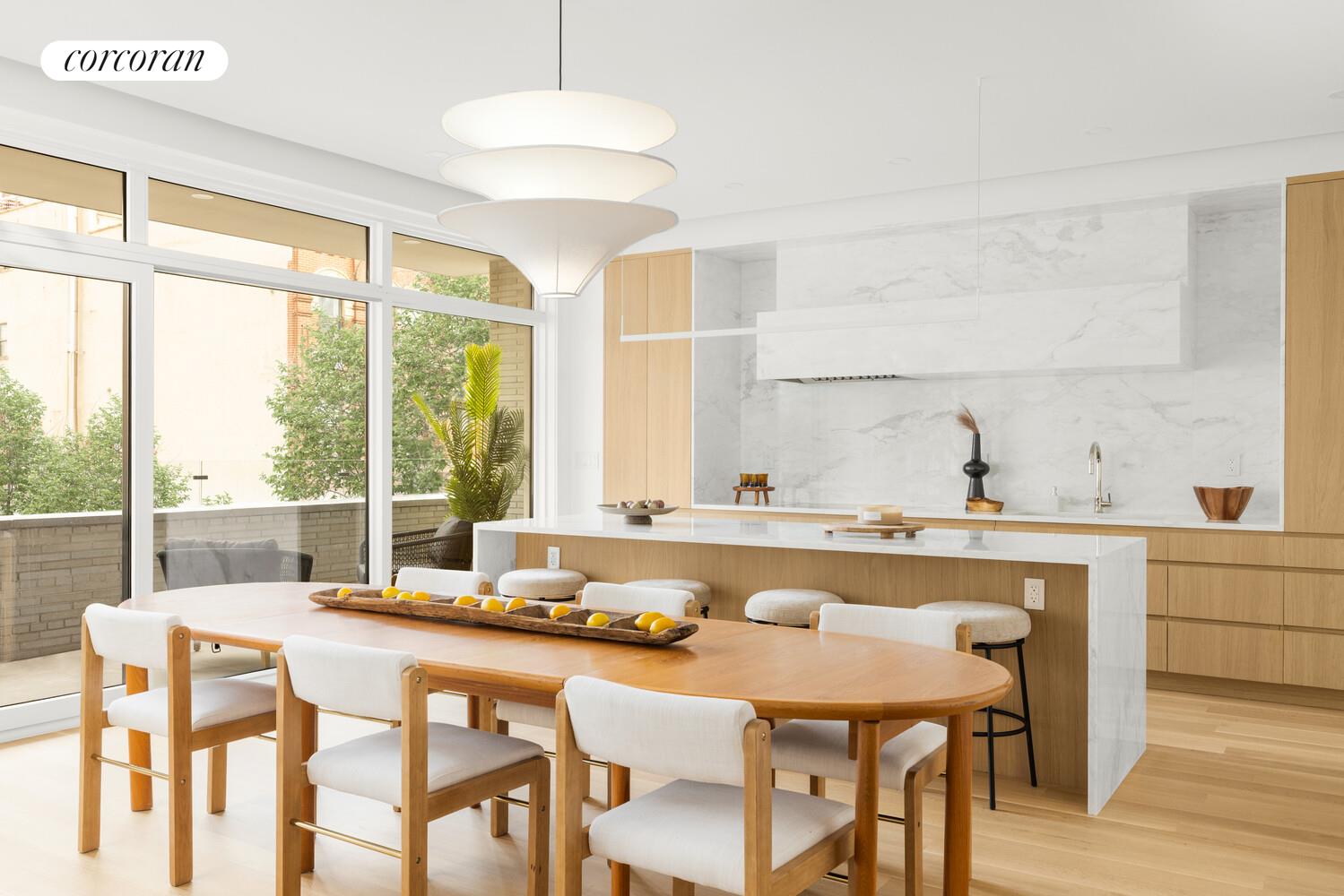420 East 75th Street, Unit 2 Manhattan, NY 10021 - Photo 3 of 22 a dining room with furniture a chandelier and wooden floor