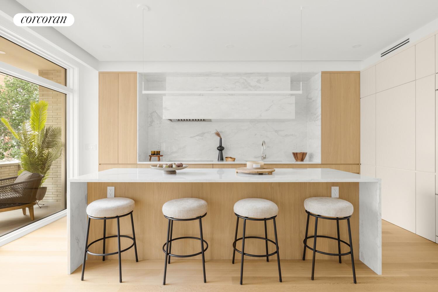 420 East 75th Street, Unit 2 Manhattan, NY 10021 - Photo 5 of 22 a kitchen with a table and chairs in it