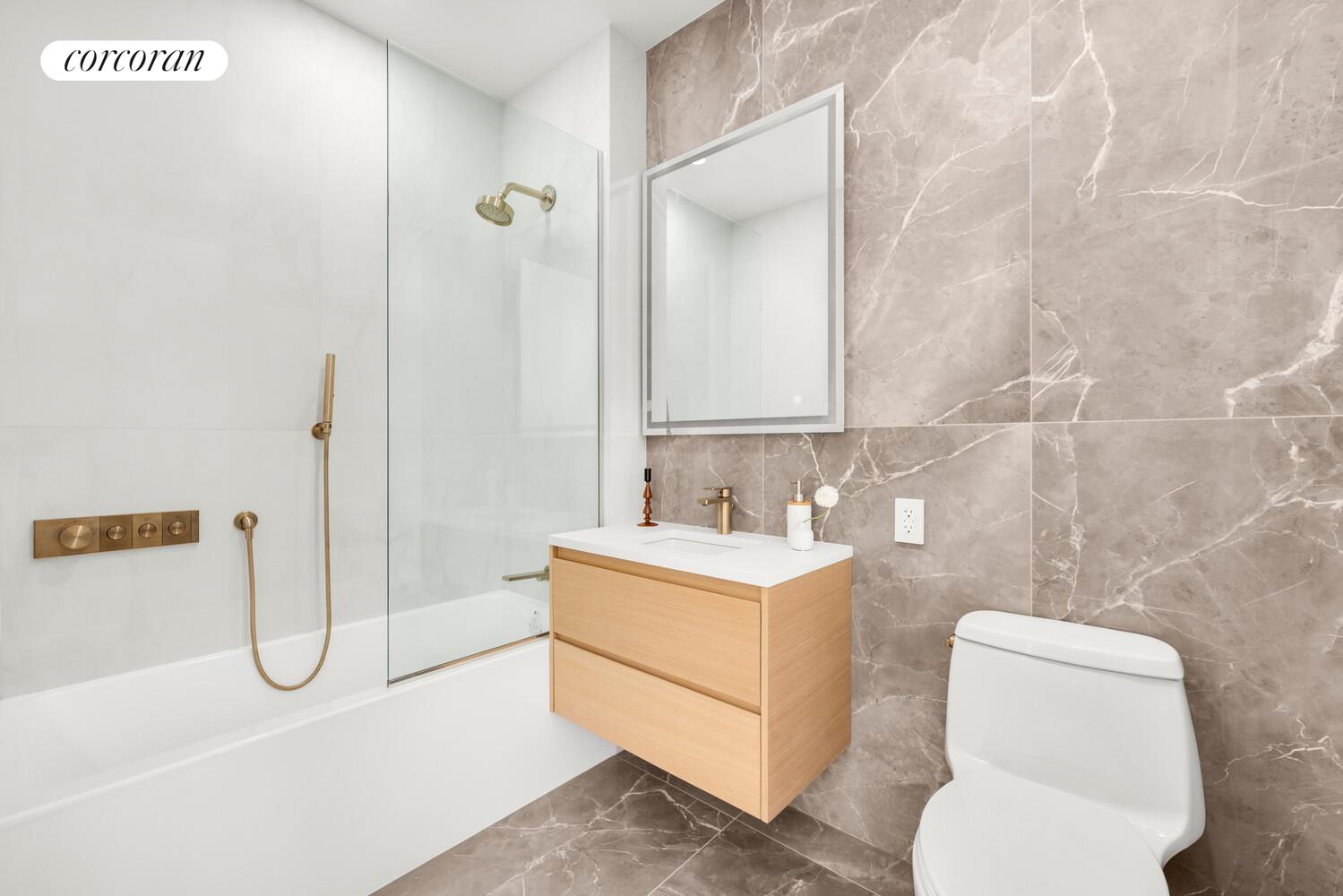 420 East 75th Street, Unit 2 Manhattan, NY 10021 - Photo 9 of 22 a bathroom with a sink a toilet and shower