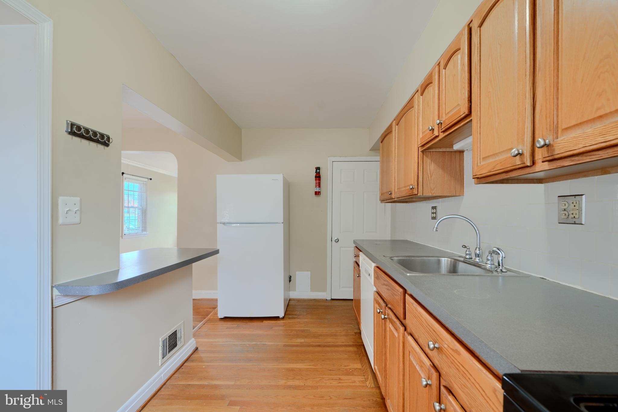 910 Radcliffe Road Towson, MD 21204 - Photo 12 of 32 a kitchen with a sink a refrigerator and cabinets