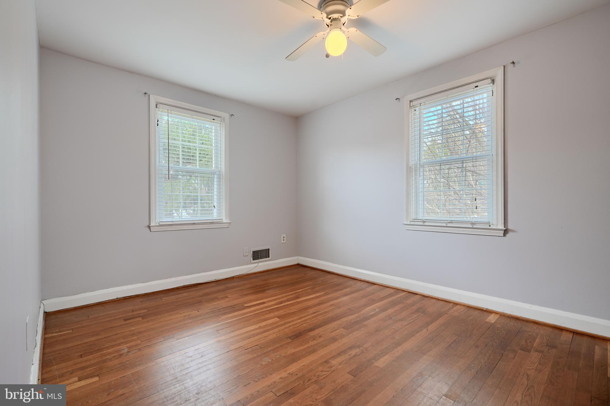 910 Radcliffe Road Towson, MD 21204 - Photo 18 of 32 a view of an empty room with wooden floor and a window