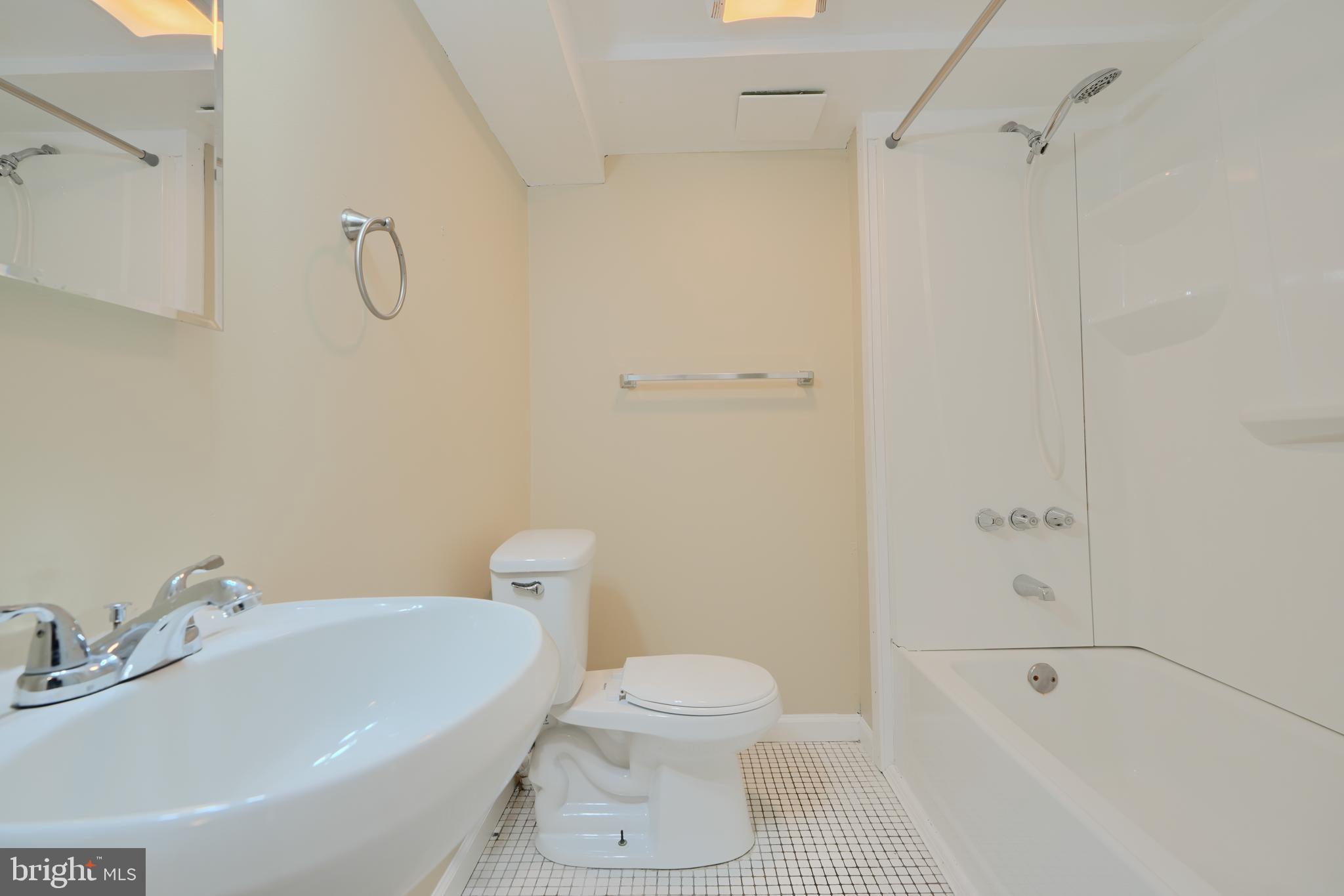 910 Radcliffe Road Towson, MD 21204 - Photo 28 of 32 a bathroom with a sink a toilet and shower