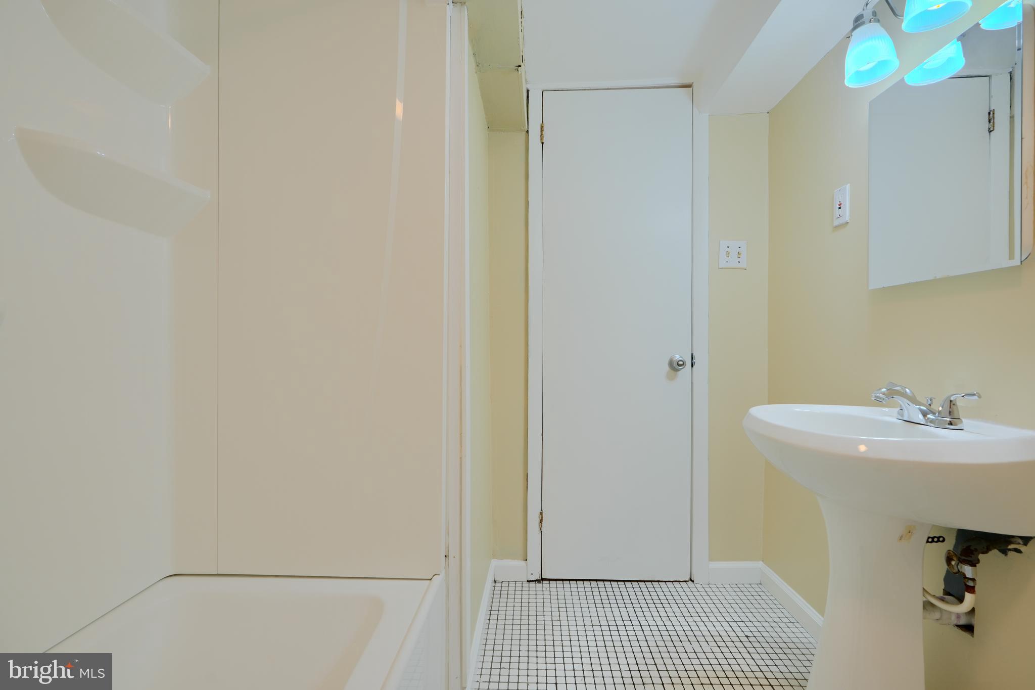 910 Radcliffe Road Towson, MD 21204 - Photo 29 of 32 a bathroom with a sink a mirror and shower