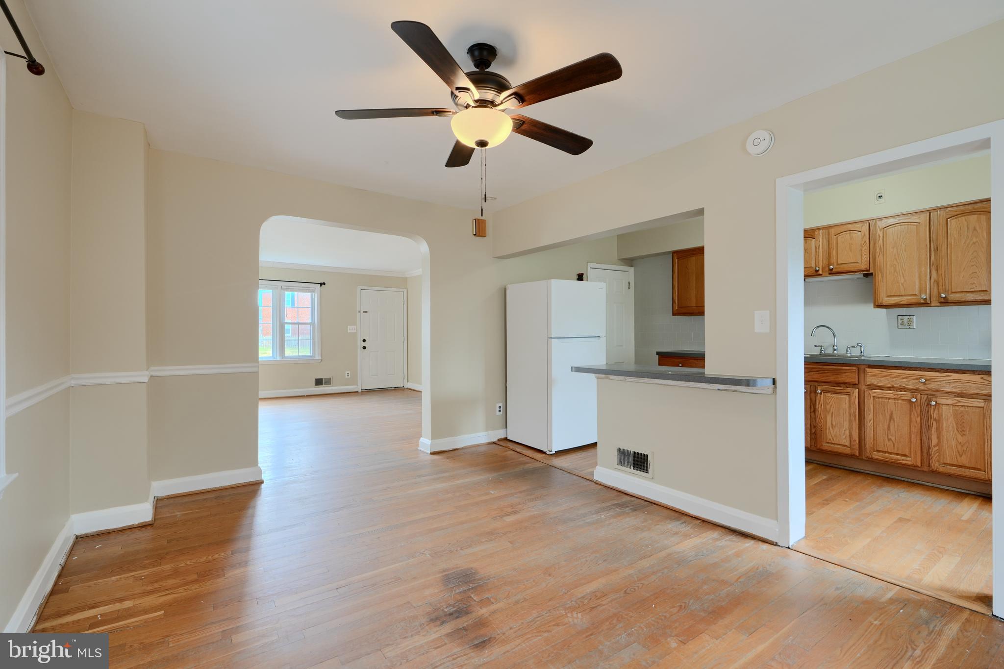 910 Radcliffe Road Towson, MD 21204 - Photo 7 of 32 a view of empty room with wooden floor and ceiling fan