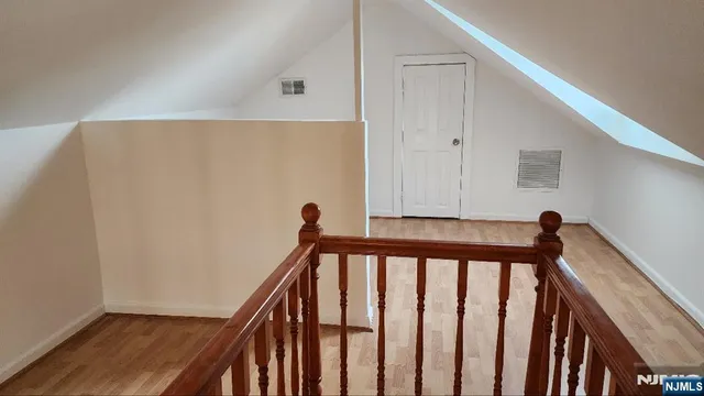 a view of a hallway with a large window and wooden floor