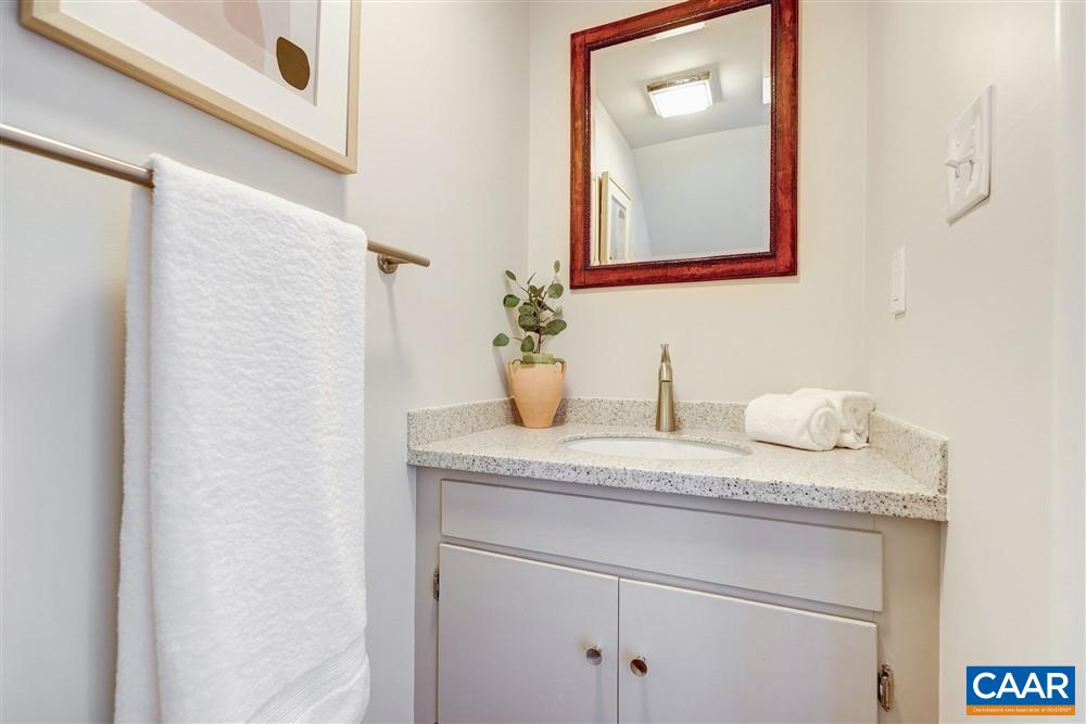 700 Merion Greene Charlottesville, VA 22901 - Photo 13 of 40 a bathroom with a granite countertop sink and a mirror