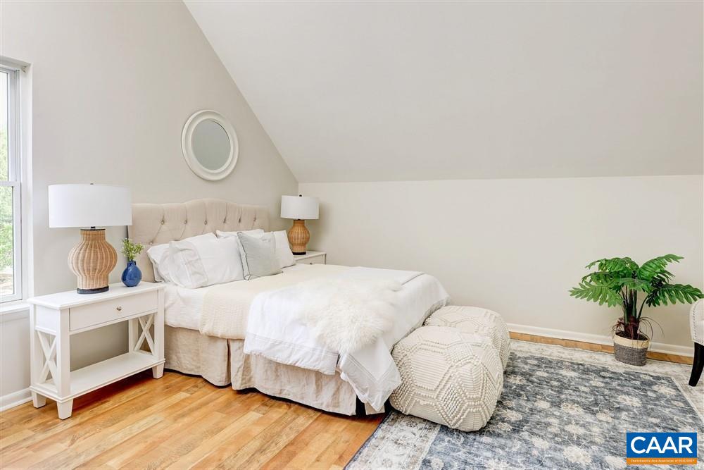 700 Merion Greene Charlottesville, VA 22901 - Photo 15 of 40 a bedroom with a bed and a potted plant