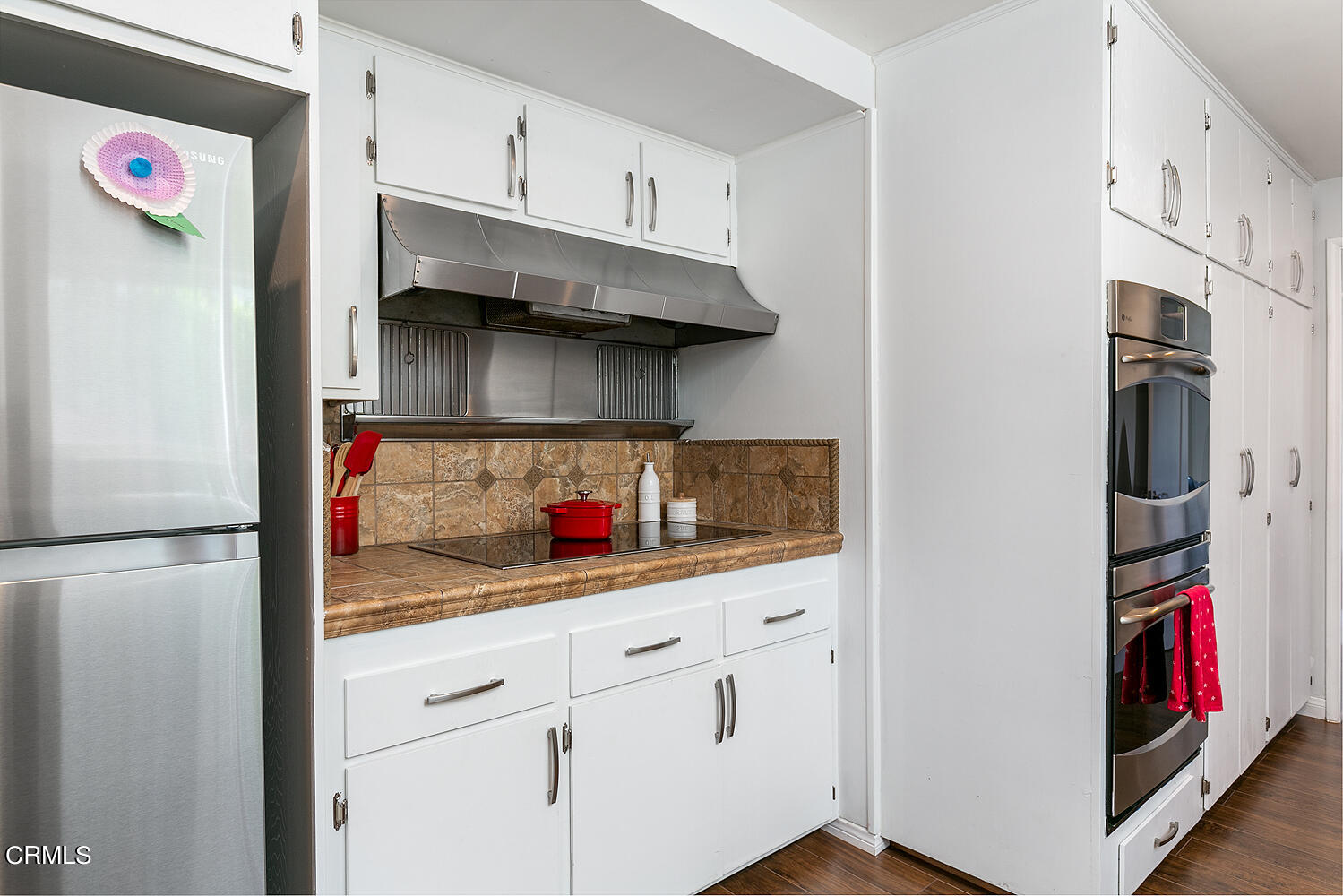1035 West Roses Road San Gabriel, CA 91775 - Photo 11 of 28 a kitchen with stainless steel appliances white cabinets and a refrigerator
