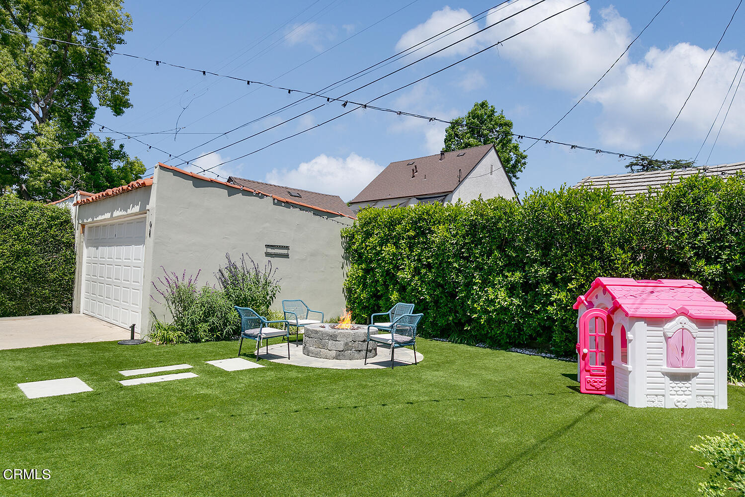 1035 West Roses Road San Gabriel, CA 91775 - Photo 27 of 28 a backyard of a house with table and chairs potted plants and a large tree