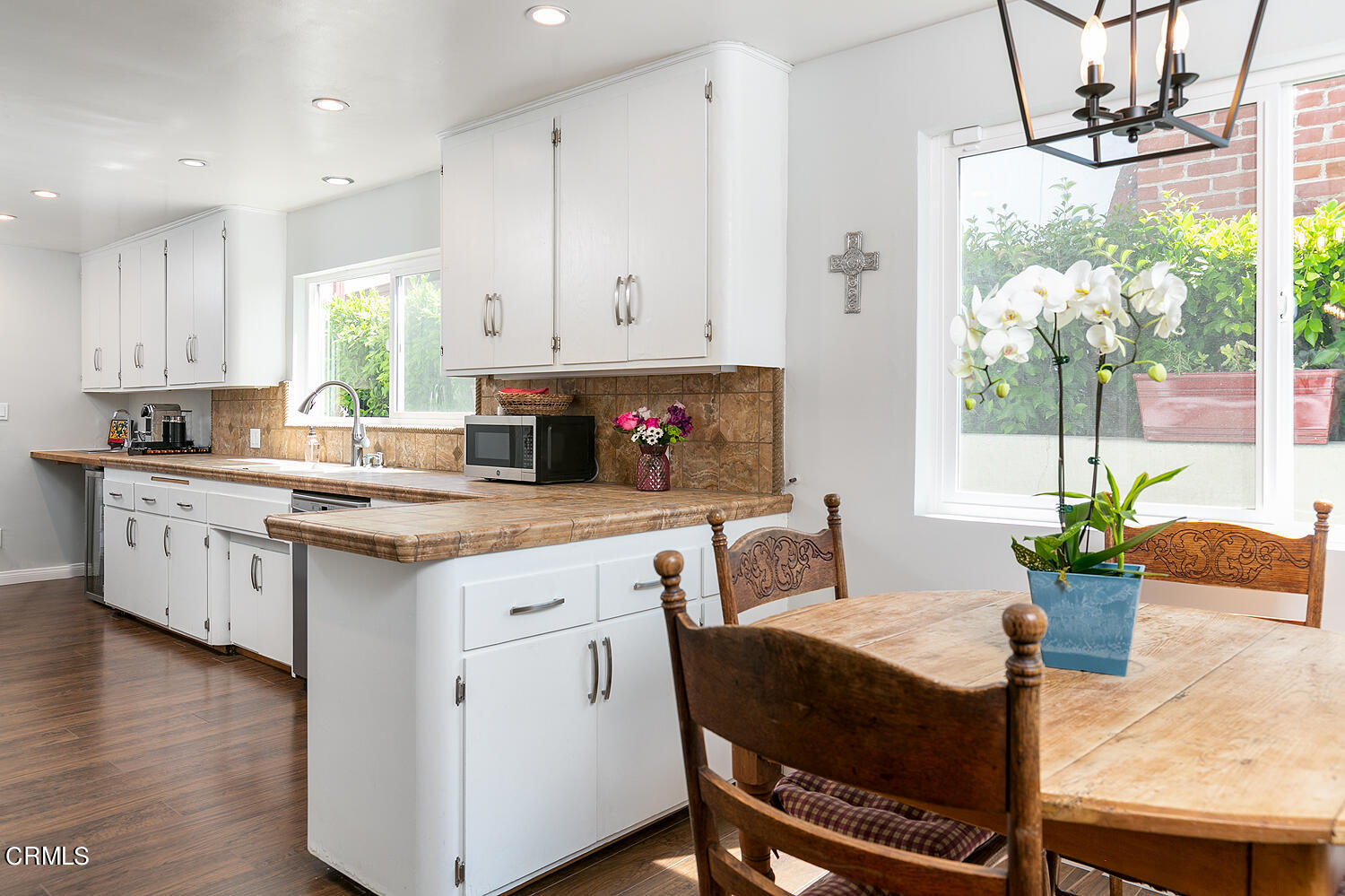 1035 West Roses Road San Gabriel, CA 91775 - Photo 10 of 28 a kitchen with a table chairs stove and cabinets