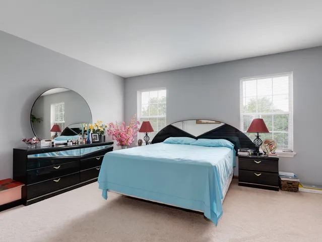 a bedroom with bed and a dresser