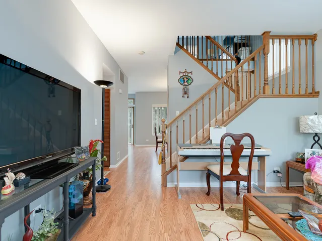 a livingroom with furniture wooden floor and a flat screen tv