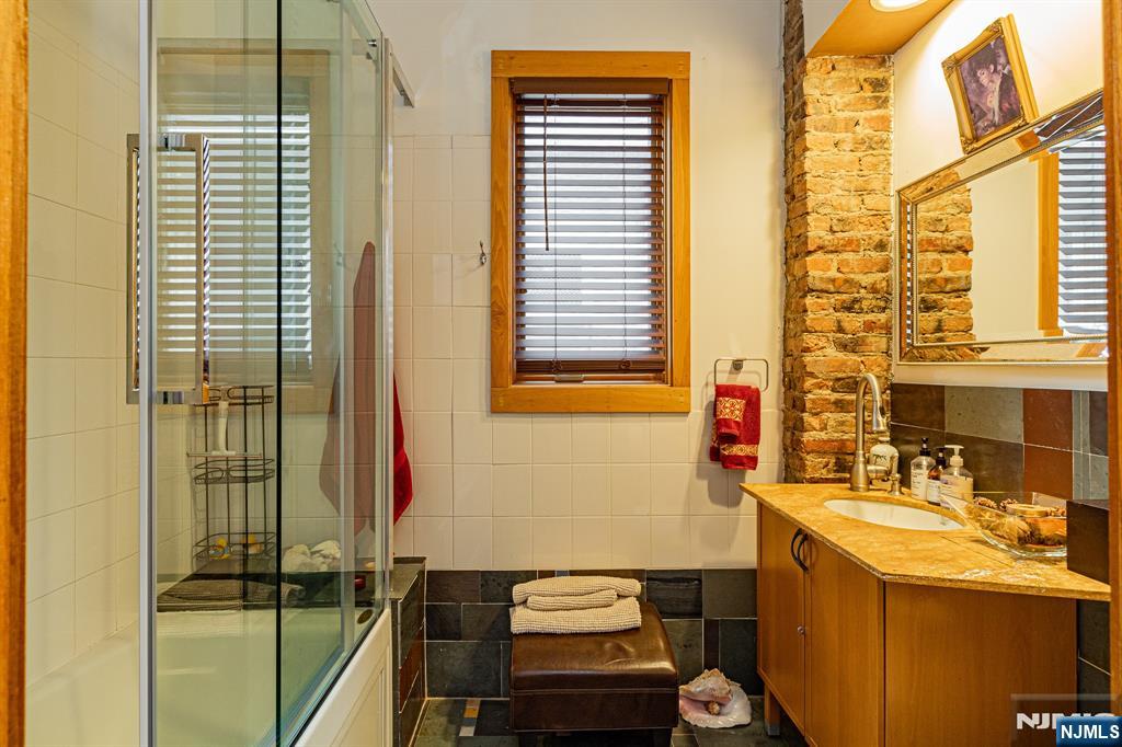152 Pine Street Cliffside Park, NJ 07010 - Photo 4 of 15 a bathroom with a sink and a mirror