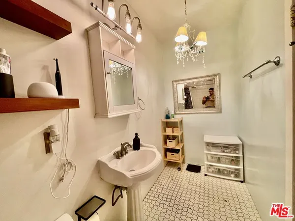 a bathroom with a sink a mirror and a shower