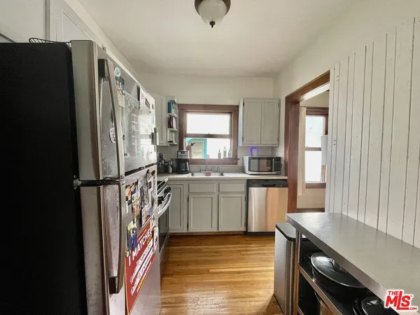 a kitchen with a refrigerator and a sink