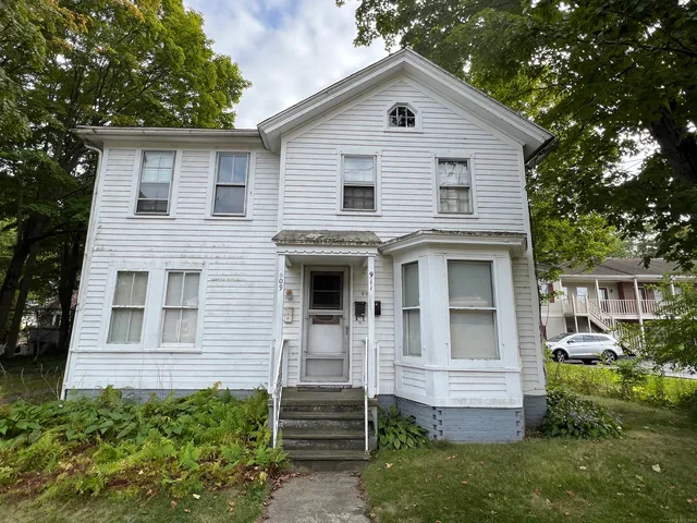 a view of house with a yard