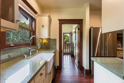 a kitchen with a stove a refrigerator and a sink