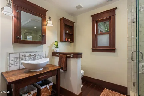 a bathroom with a sink toilet and mirror