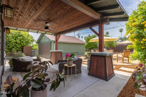 a view of patio with chairs and table under an umbrella