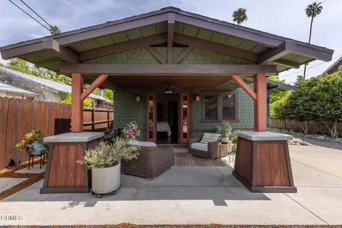 a view of a porch with chairs and backyard