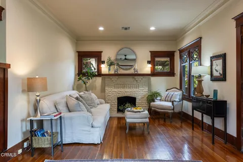 a living room with fireplace furniture and a wooden floor