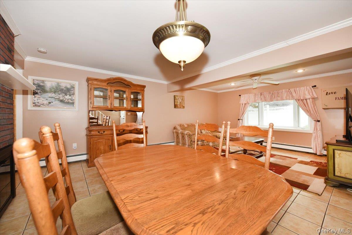 307 Blacksmith Road Levittown, NY 11756 - Photo 9 of 27 a room with lots of chairs and chandelier