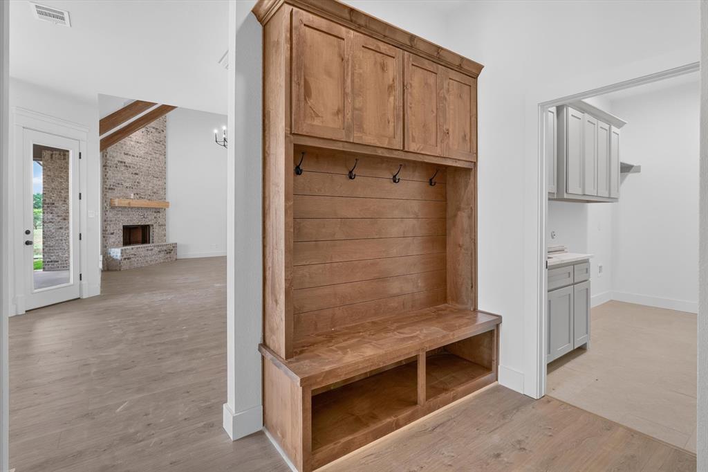 471 Red Bird Drive Springtown, TX 76082 - Photo 16 of 35 Built-in wood-finish hall tree with upper cabinetry, storage bench, and coat hooks