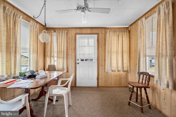 a dining room with furniture and window