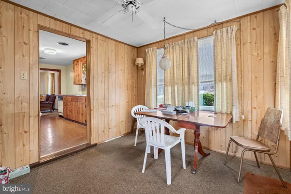a view of a dining room with furniture and a window