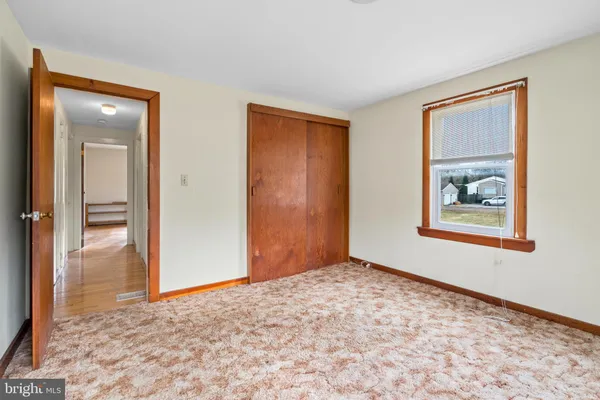 wooden floor in an empty room and a window