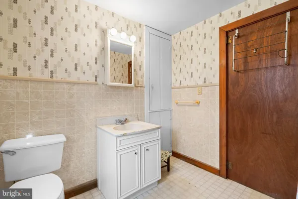 a bathroom with a toilet sink and shower