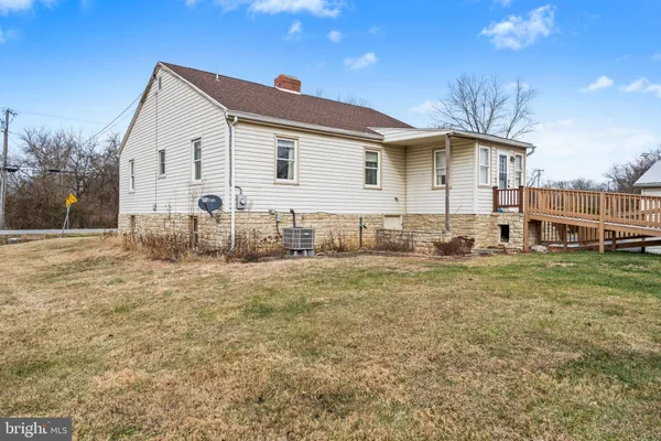 a view of a white house with a yard