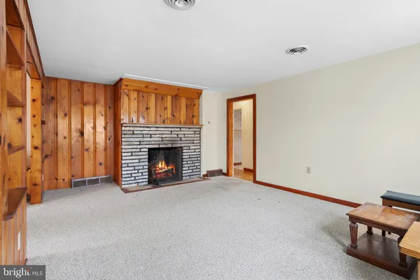 a view of an empty room with a fireplace