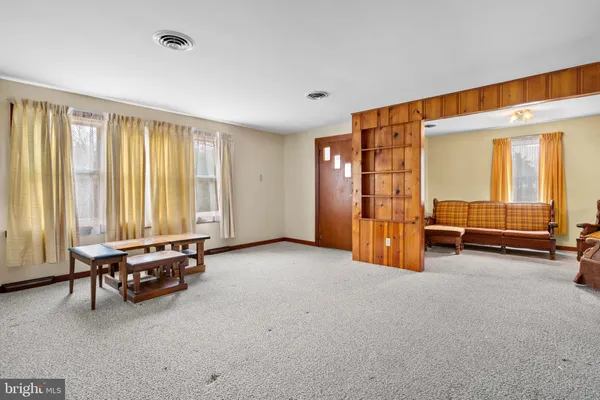 a living room with furniture and large windows