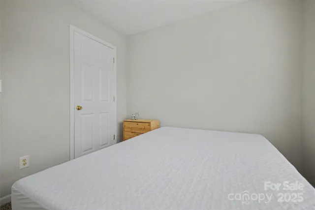 a bedroom with a bed and a wall painting