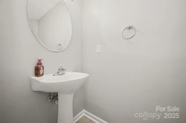 a bathroom with a sink a mirror and a shower