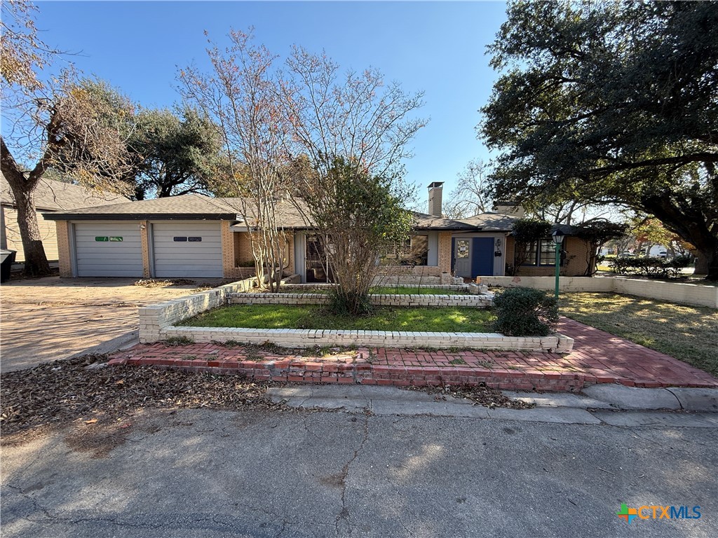 1701 North 13th Street Temple, TX 76501 - Photo 1 of 48 a front view of a house with a yard and garage
