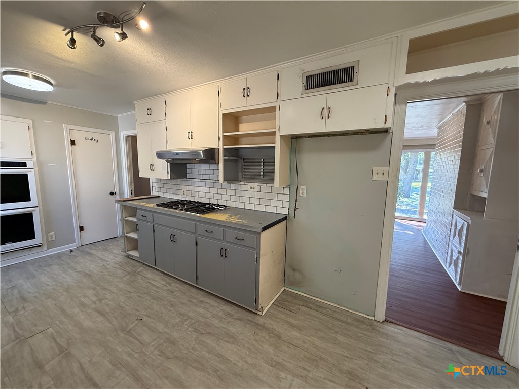 1701 North 13th Street Temple, TX 76501 - Photo 14 of 48 a kitchen with stainless steel appliances a refrigerator and a stove top oven