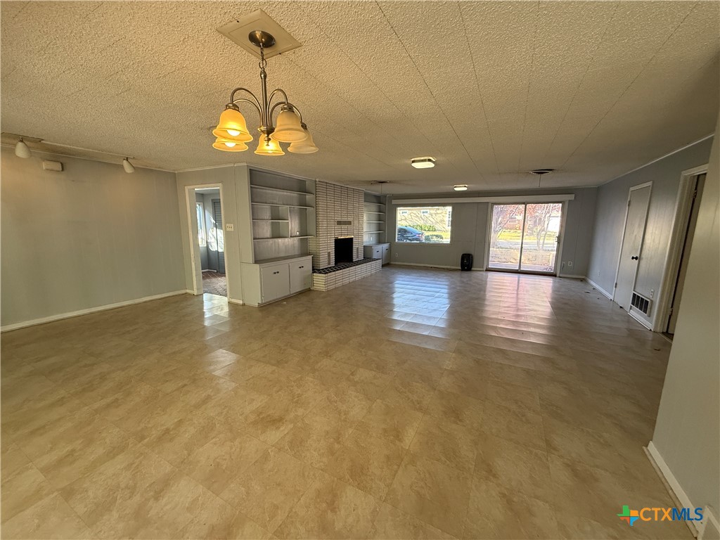 1701 North 13th Street Temple, TX 76501 - Photo 3 of 48 an empty room with kitchen and windows