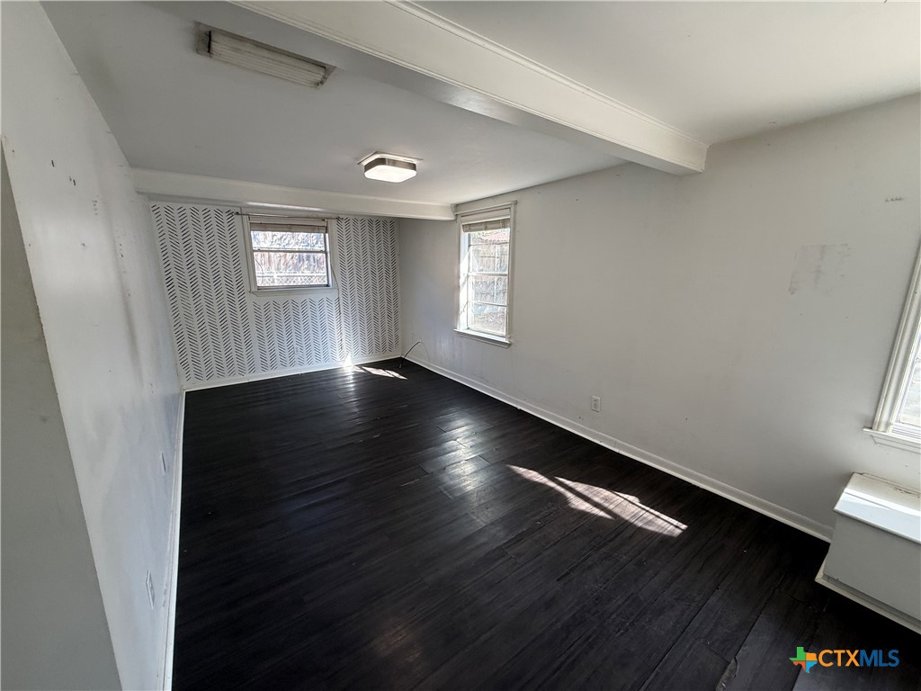 1701 North 13th Street Temple, TX 76501 - Photo 37 of 48 an empty room with wooden floor and windows