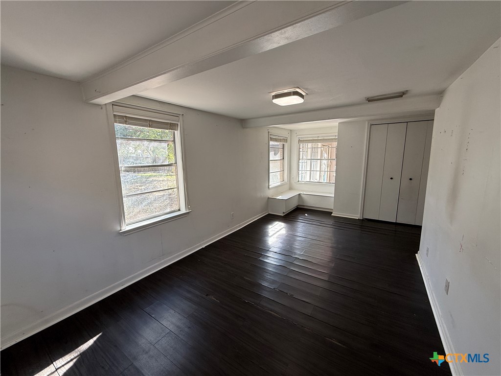1701 North 13th Street Temple, TX 76501 - Photo 40 of 48 an empty room with wooden floor and windows