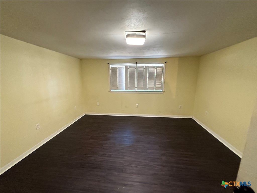 1701 North 13th Street Temple, TX 76501 - Photo 41 of 48 a view of an empty room with wooden floor and a window