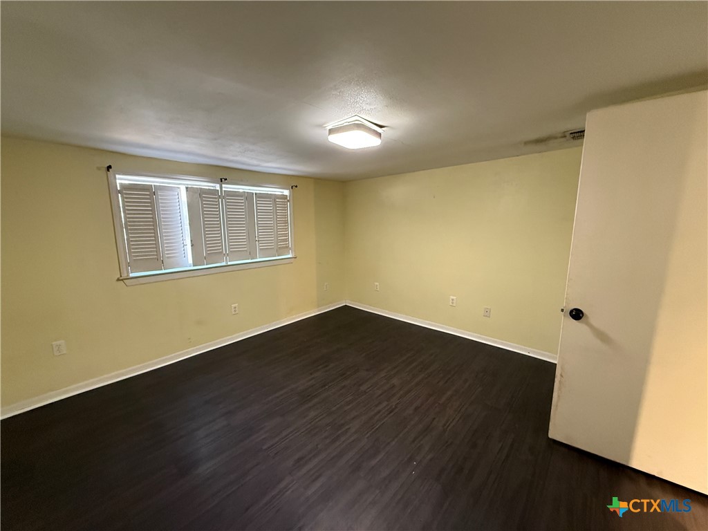 1701 North 13th Street Temple, TX 76501 - Photo 42 of 48 a view of an empty room with wooden floor and a window