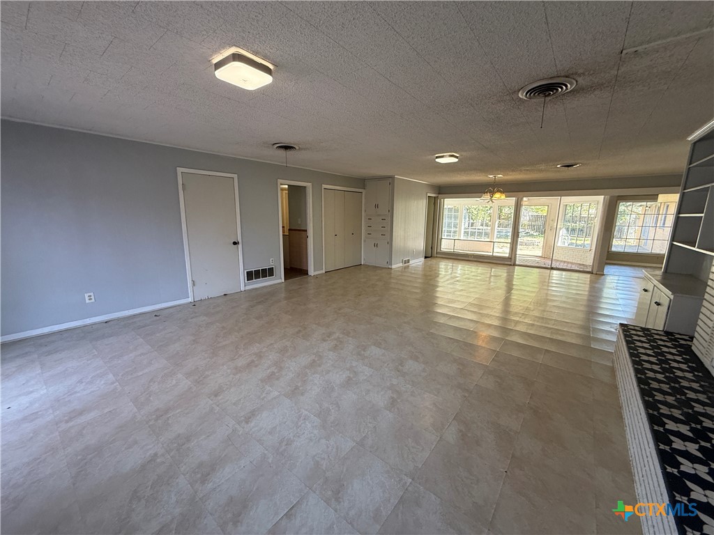 1701 North 13th Street Temple, TX 76501 - Photo 5 of 48 an empty room with large windows