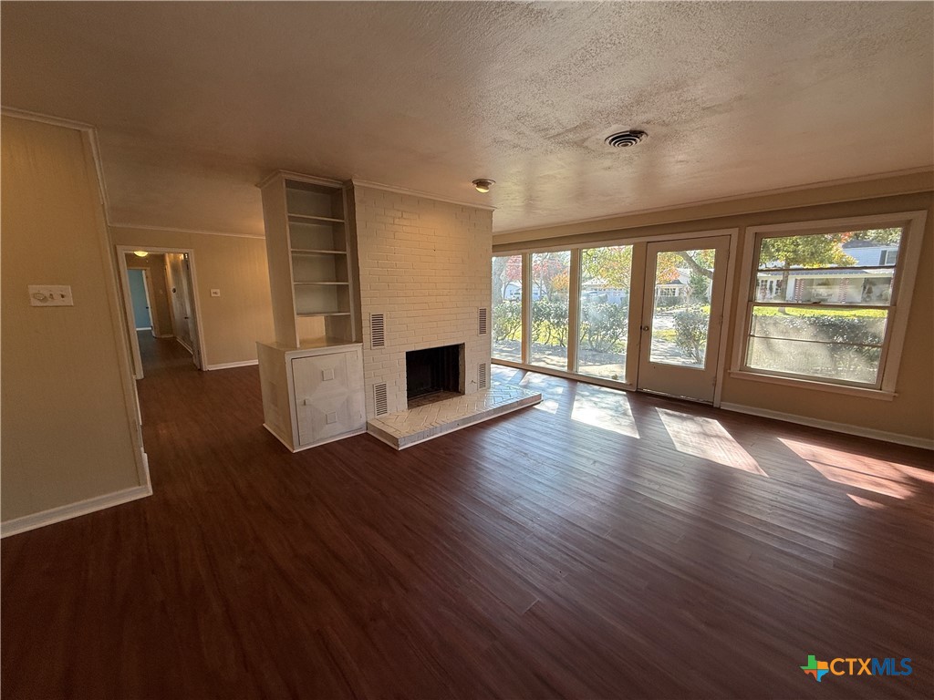 1701 North 13th Street Temple, TX 76501 - Photo 8 of 48 a view of an empty room with wooden floor and a window