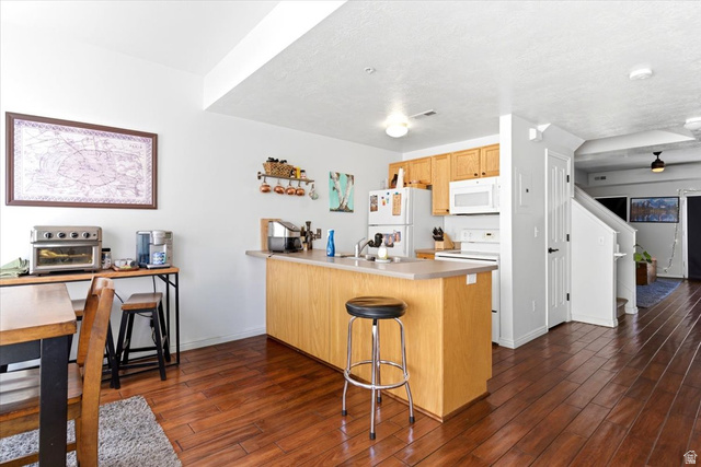 161 25th Street, Unit 6B Ogden, UT 84401 - Photo 6 of 20 Kitchen with light wood cabinetry, white appliances, and light-toned countertops