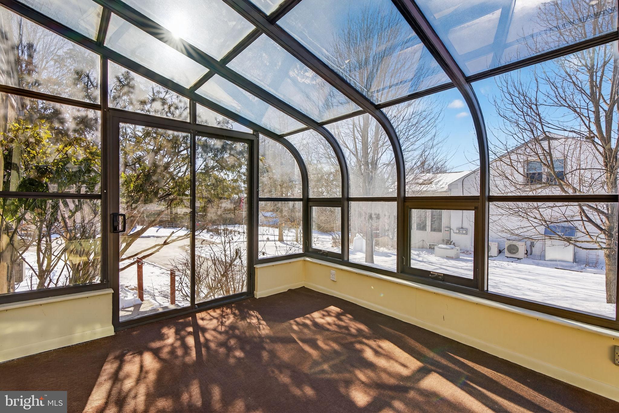 2016 North Trooper Road Norristown, PA 19403 - Photo 13 of 53 Sunlit sunroom with serene winter views.